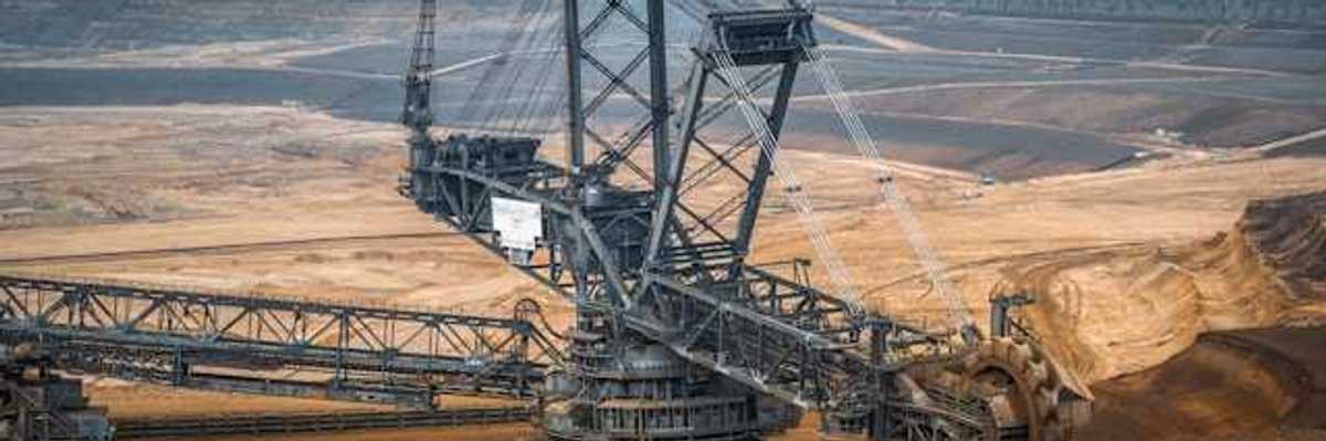 A barren environment with large mining equipment digging into the earth