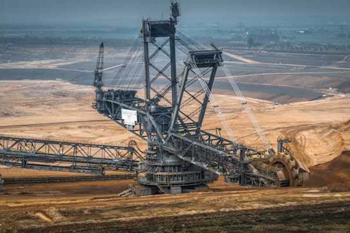 A barren environment with large mining equipment digging into the earth