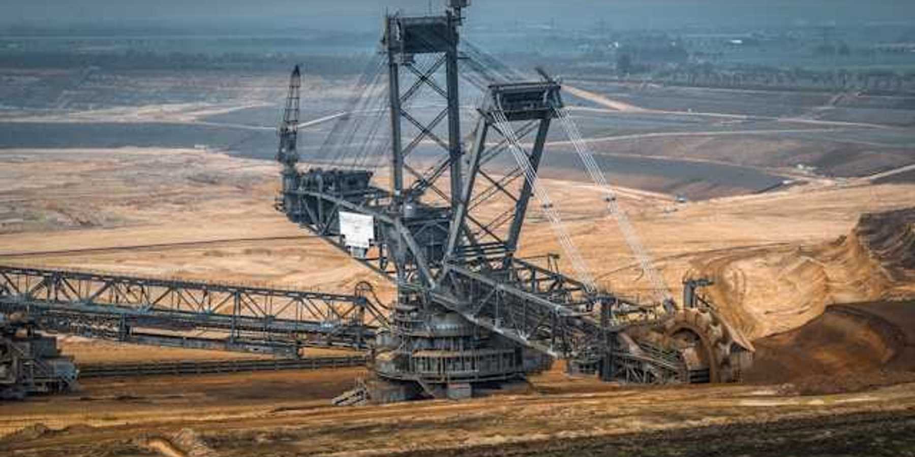 A barren environment with large mining equipment digging into the earth