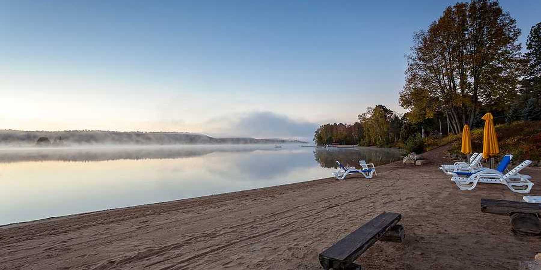 A beach on a misty lake