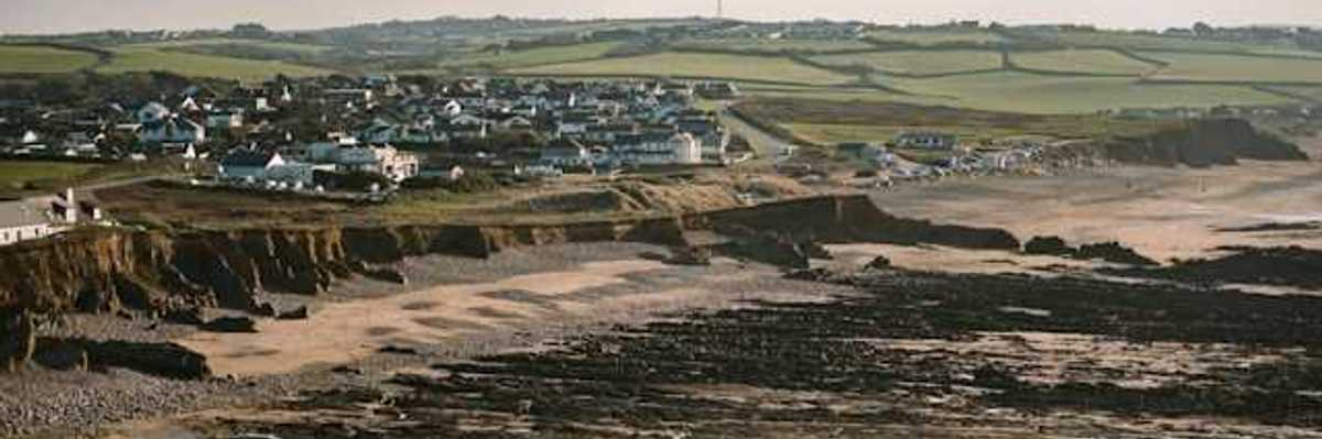 A beach with houses on it and dried up land