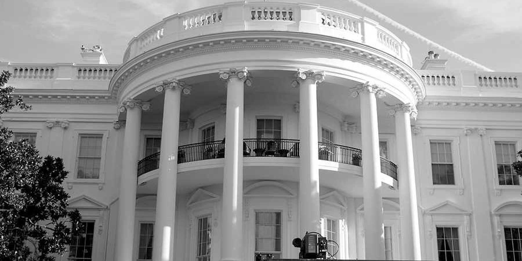 A black and white photo of the front of the White House in Washington, DC