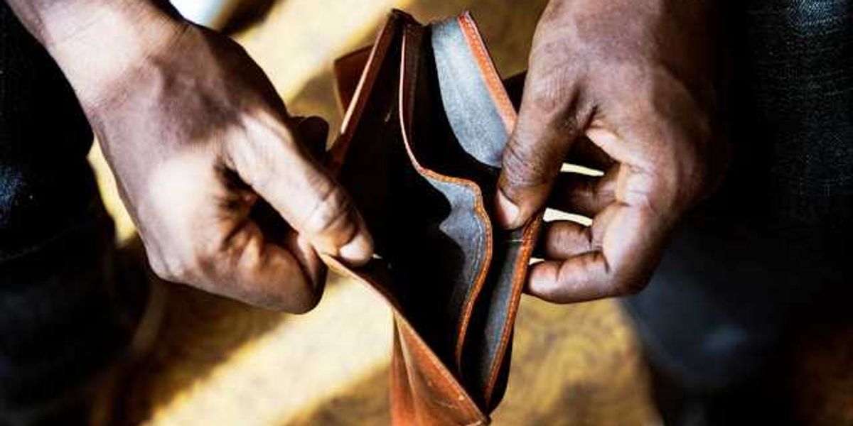 A Black person's hands holding an empty wallet