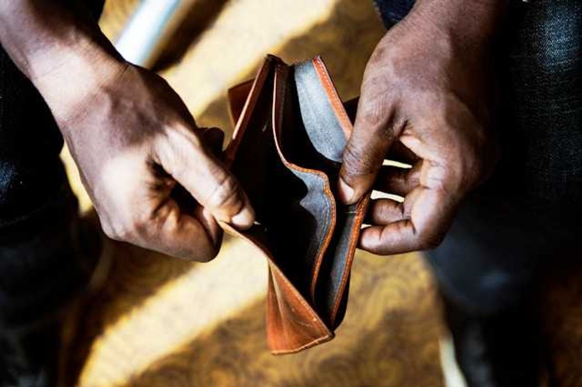 A Black person's hands holding an empty wallet