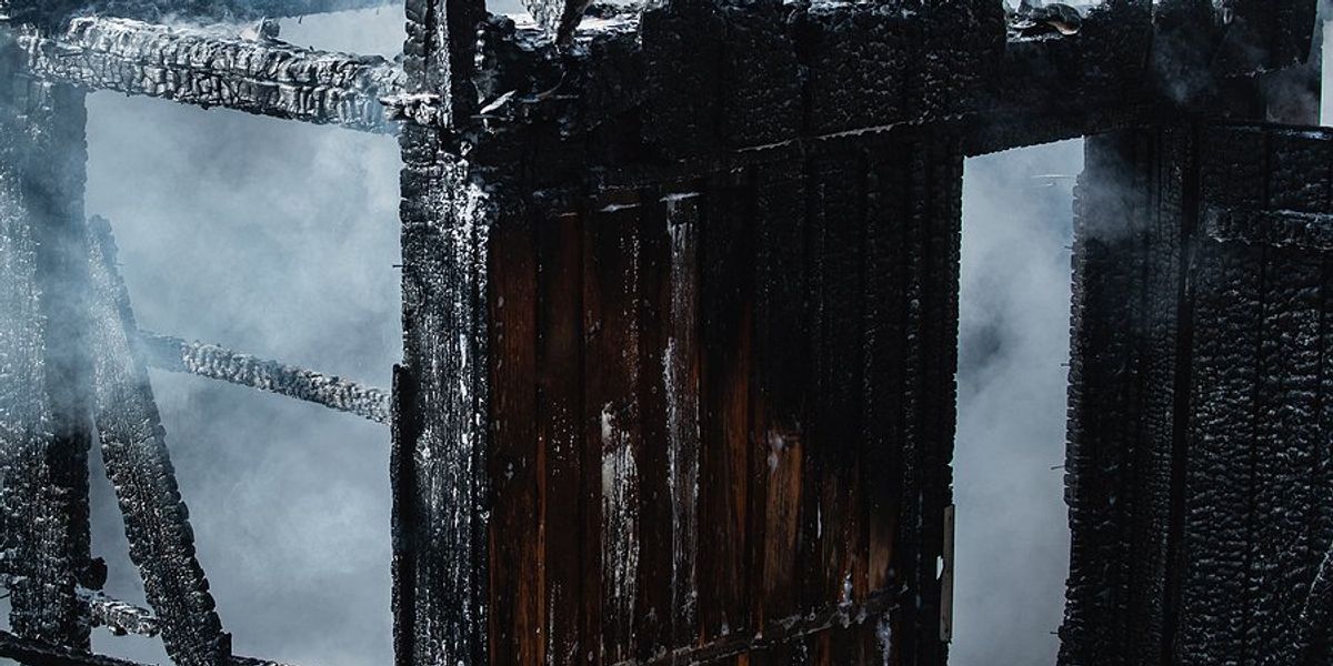 A blackened shell of a burned home.
