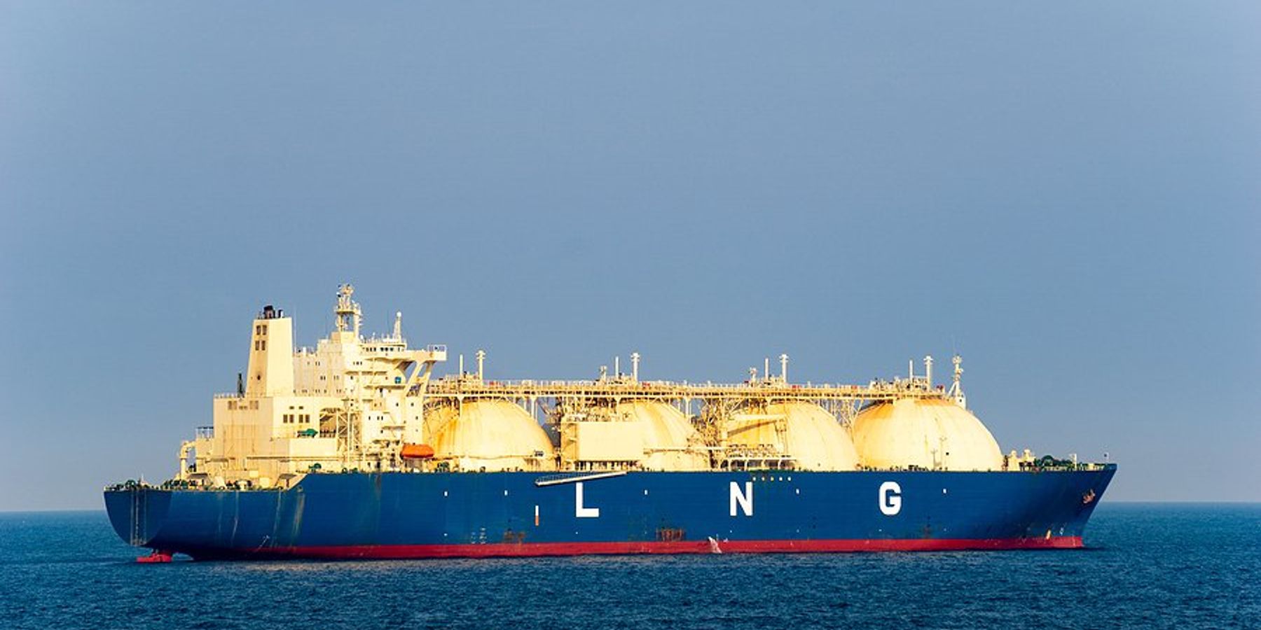 A blue and white ship at sea with LNG written on the side of it.