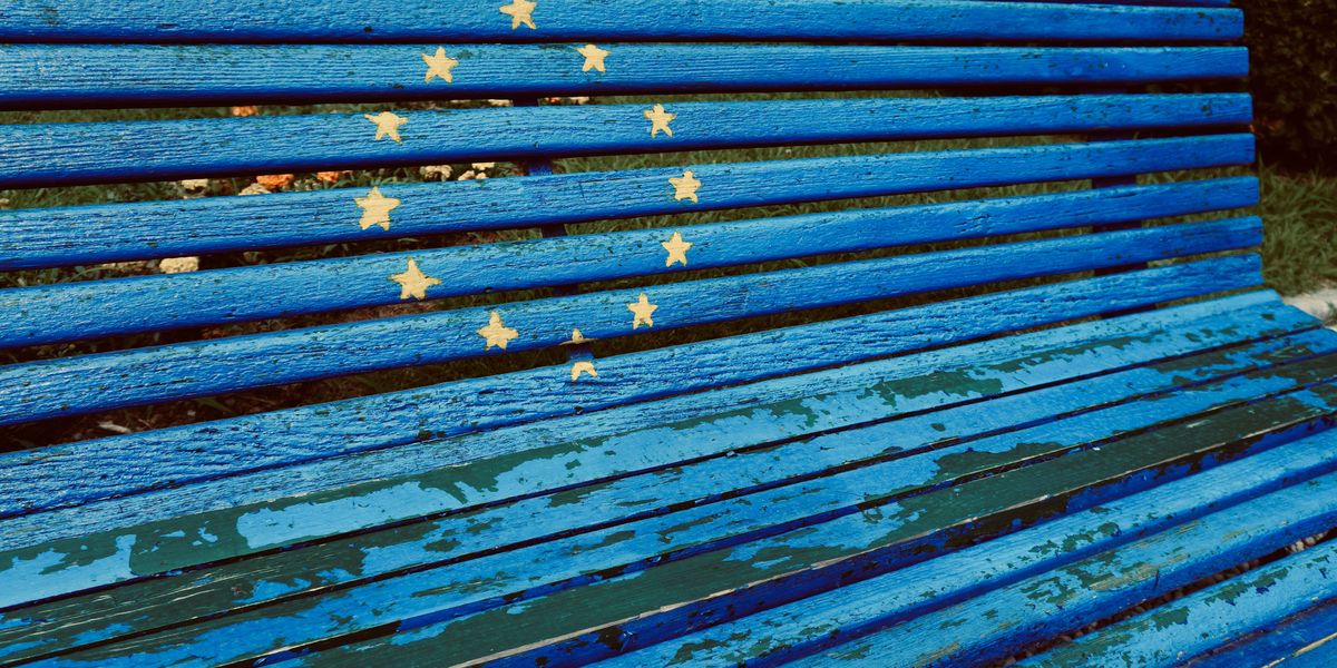 a blue bench with yellow stars painted on it in a circle.