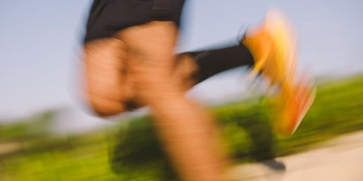 A blurry picture of a jogger's legs.