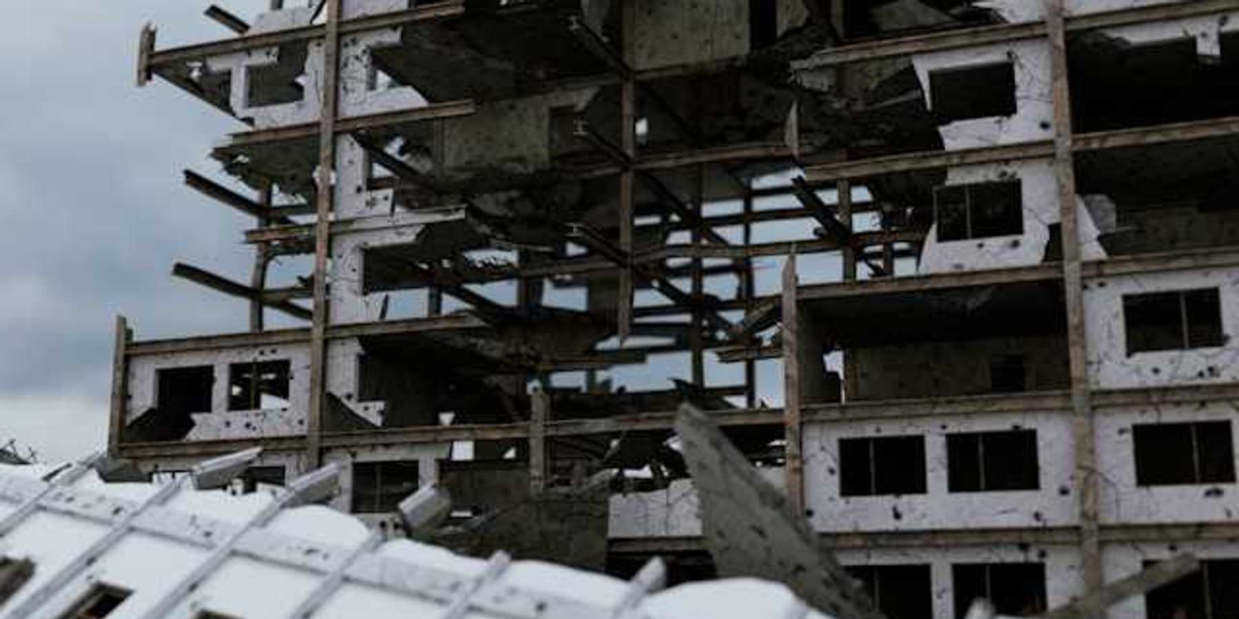 A bombed building against a grey sky