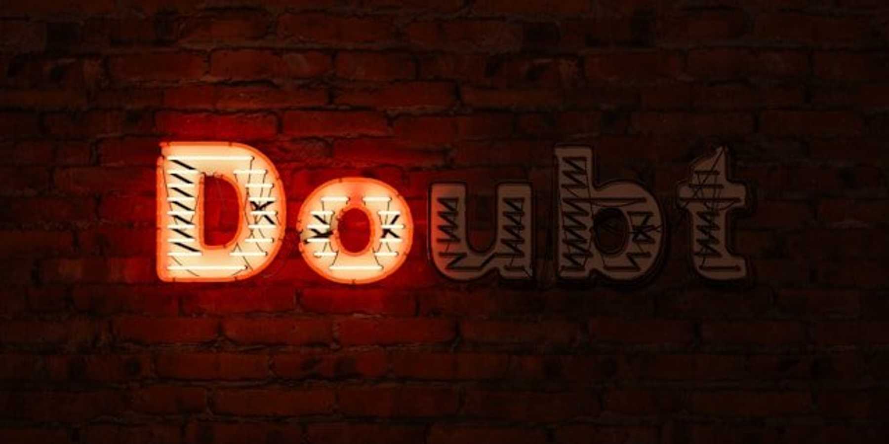 A brick wall with the word Doubt on it, with the D and the O illuminated in red.
