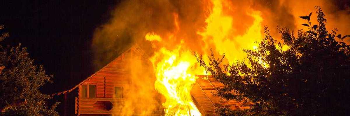 A burning home viewed at night
