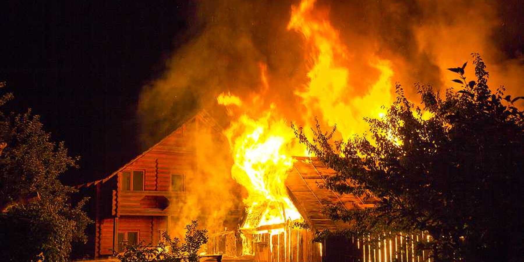 A burning home viewed at night