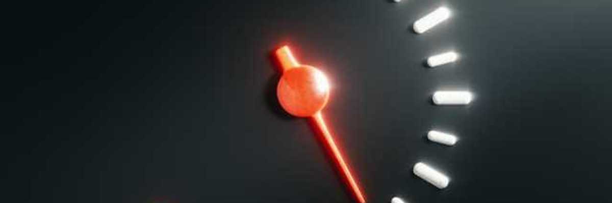 A car's fuel gauge showing empty