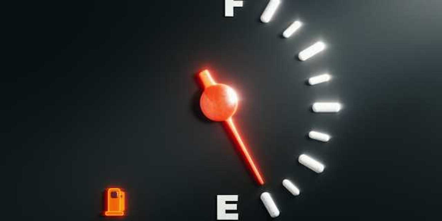 A car's fuel gauge showing empty
