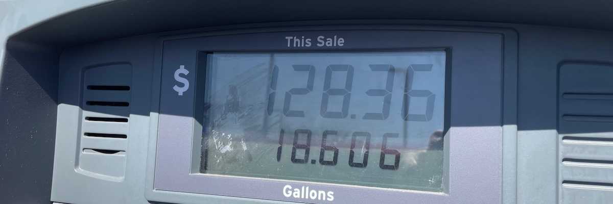 A Chevron gas pump showing a sale of $128.36 for 18.606 gallons