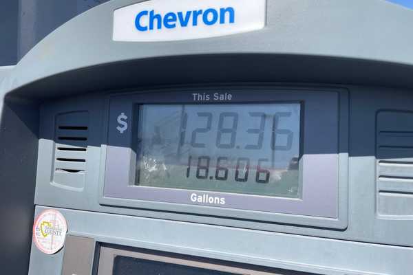 A Chevron gas pump showing a sale of $128.36 for 18.606 gallons