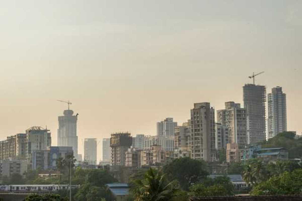 A city skyline with a layer of haze above the buildings