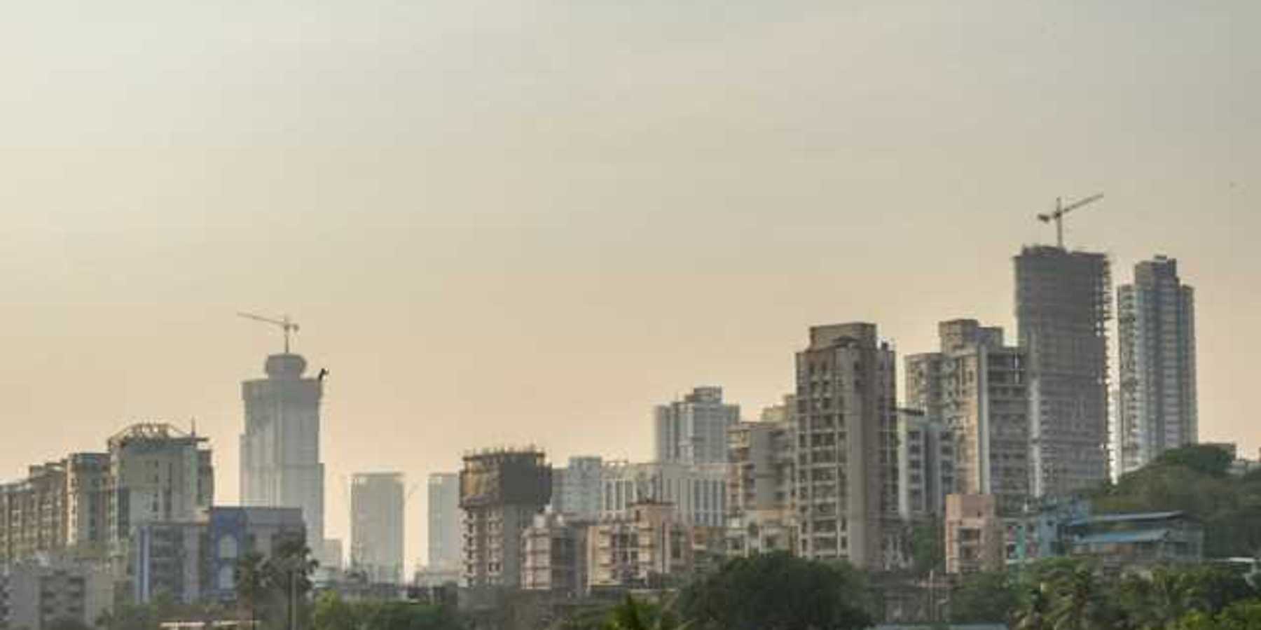 A city skyline with a layer of haze above the buildings