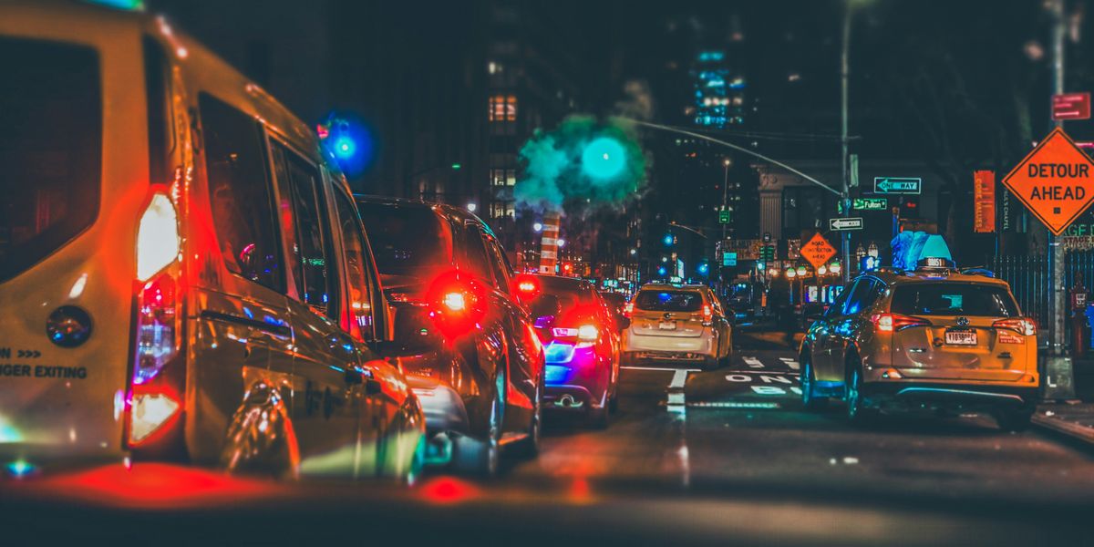 a city street filled with lots of traffic and lights at night.