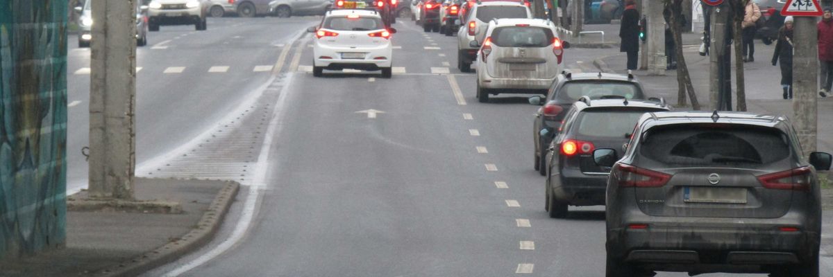 A city street filled with lots of traffic.