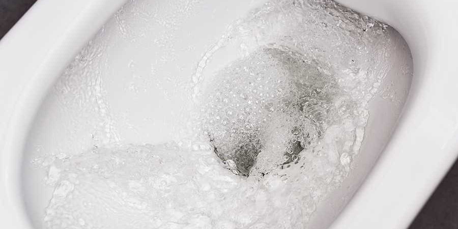 A close up of a bidet bowl with water in it