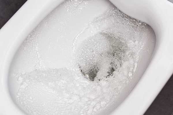 A close up of a bidet bowl with water in it