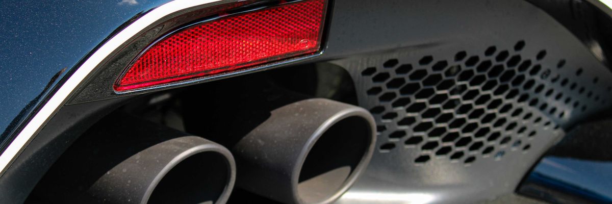 a close up of the tail lights and exhaust pipes of a car.