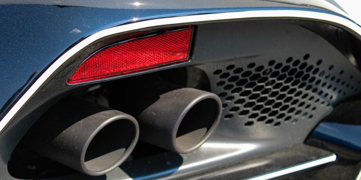 a close up of the tail lights and exhaust pipes of a car.