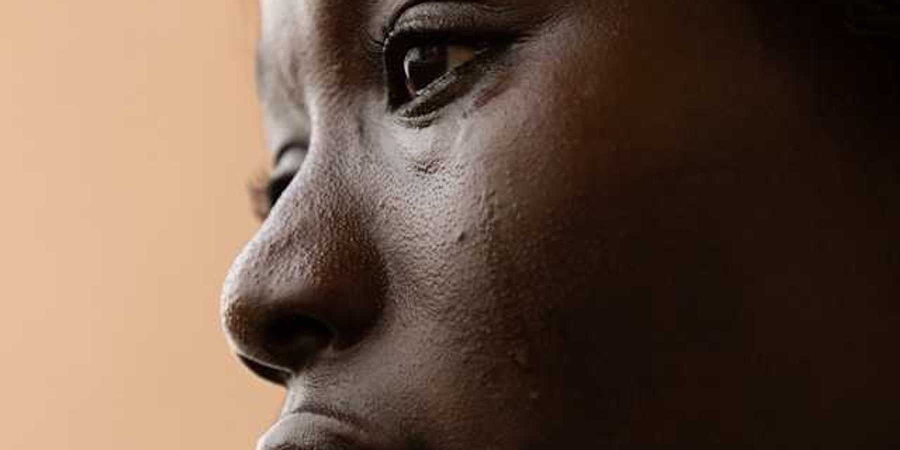 A closeup of a crying Black woman