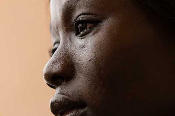 A closeup of a crying Black woman