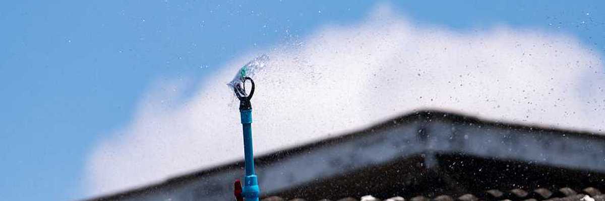 A closeup of a roof with a sprinkler system installed on it