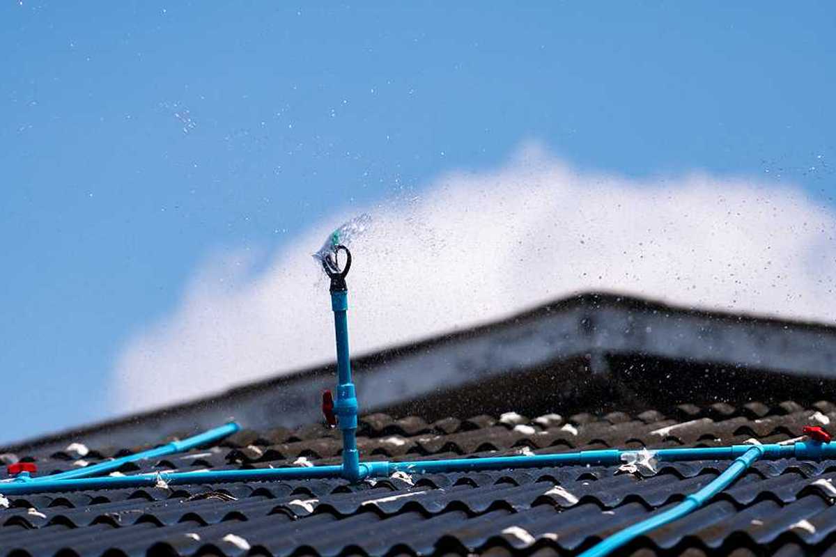 A closeup of a roof with a sprinkler system installed on it