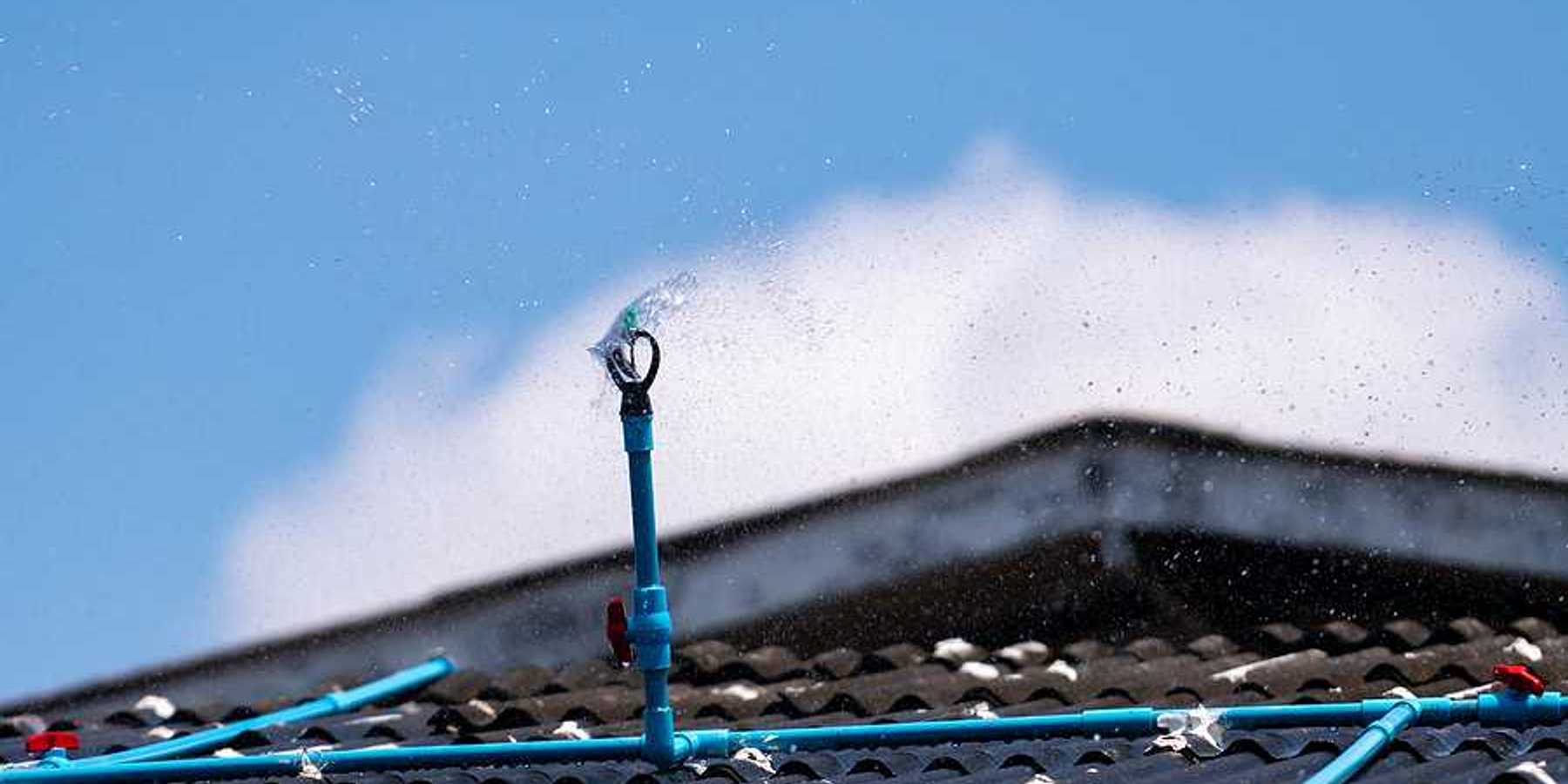 A closeup of a roof with a sprinkler system installed on it