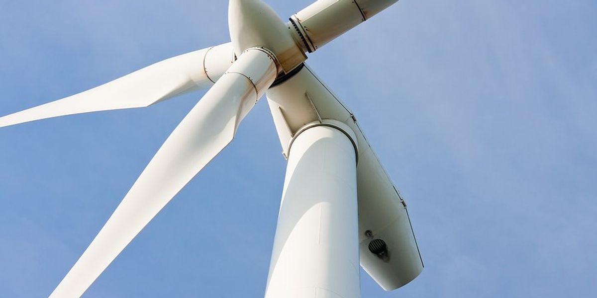 A closeup of the top of a wind turbine from below.