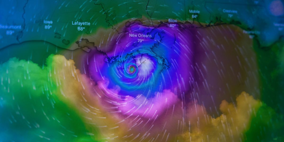 A colorful satellite photo of a hurricane nearing the coast.