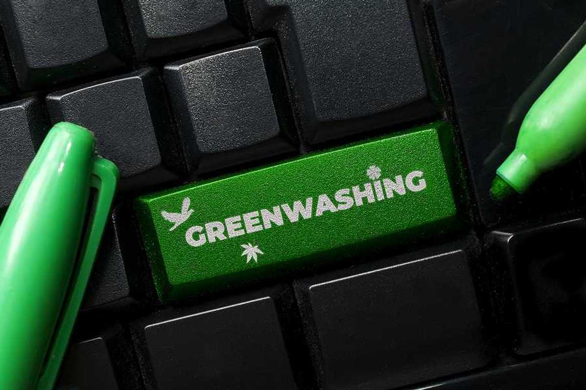 A computer keyboard with a green button called Greenwashing