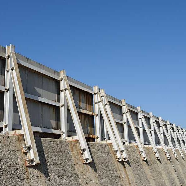 A concrete and metal seawall stretching into the distance