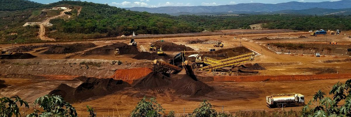 a construction site with a large amount of dirt in the foreground