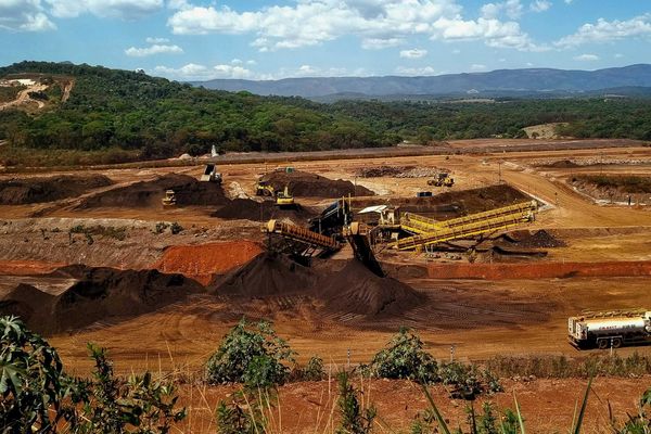 a construction site with a large amount of dirt in the foreground