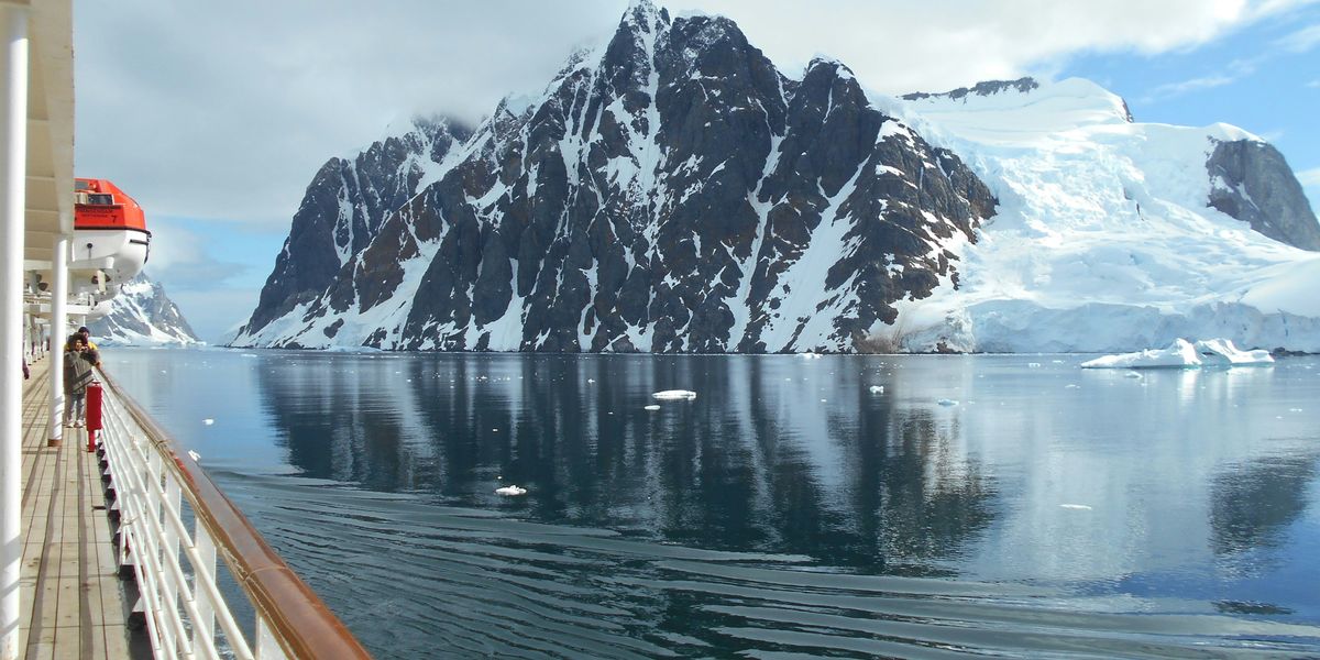 a cruise ship with an iceberg in the background.