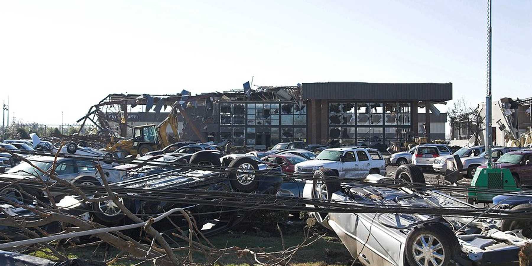 A damaged business with overturned cars.