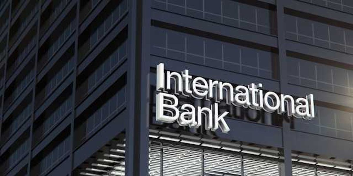 A dark gray office building with the words International Bank on the side