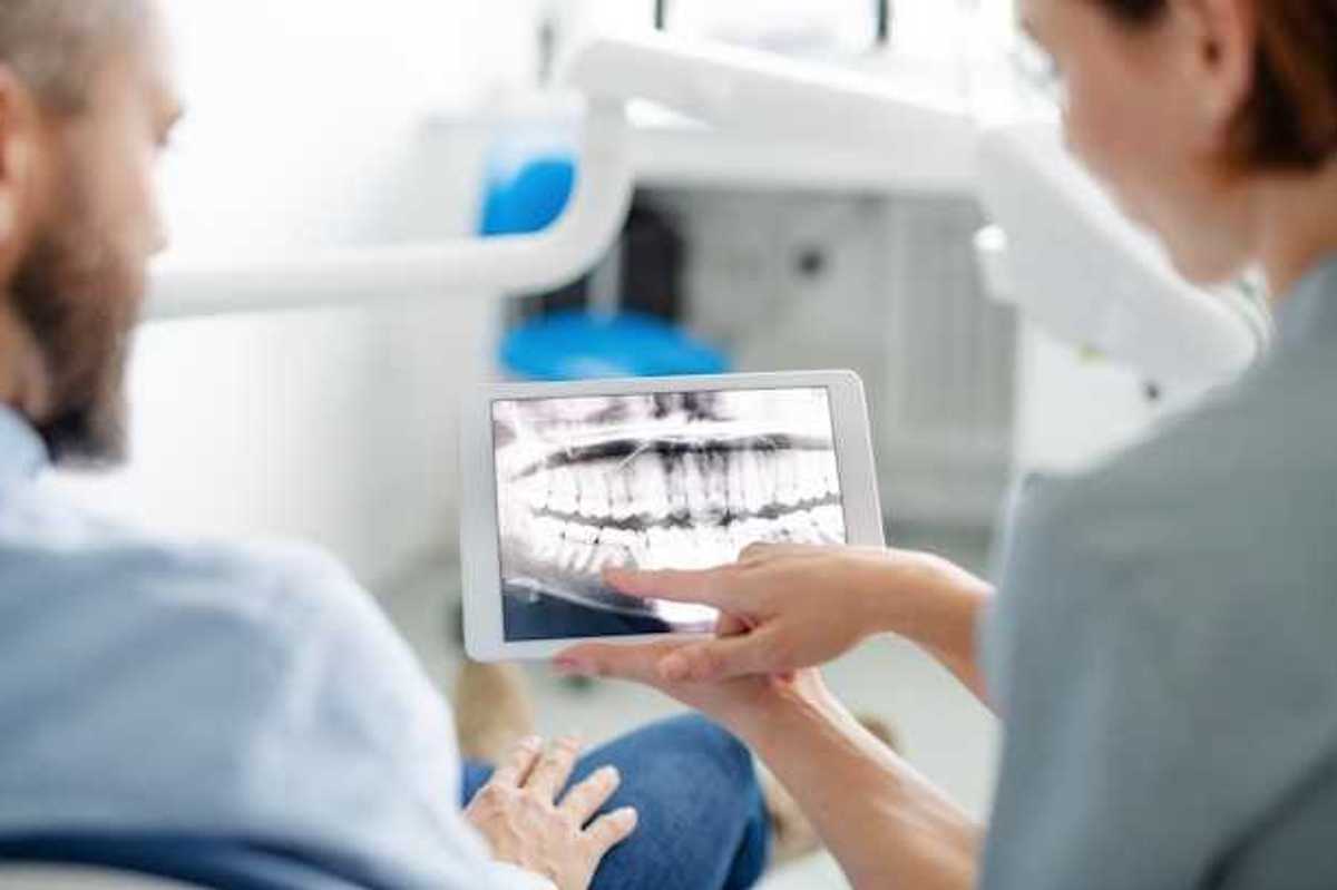 A dentist showing a patient his xrays