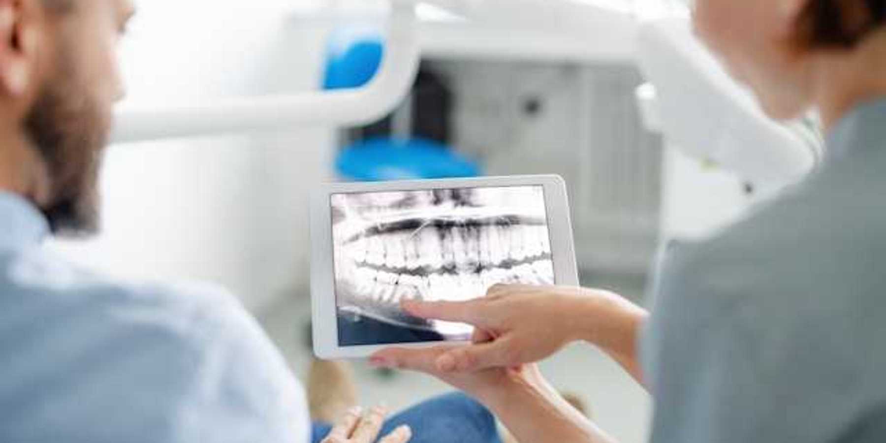 A dentist showing a patient his xrays