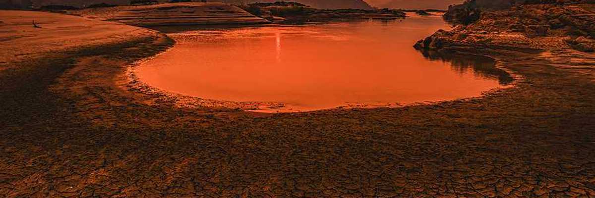A drying lakebed under a setting sun