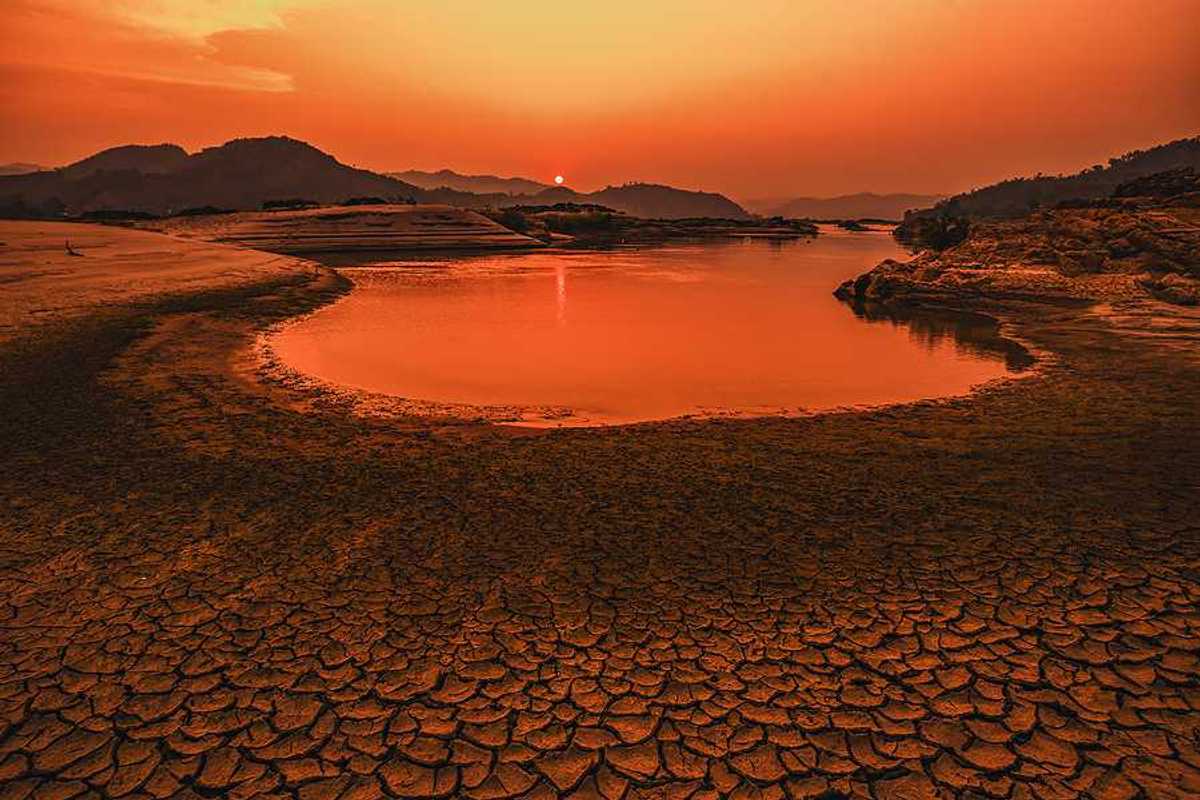 A drying lakebed under a setting sun