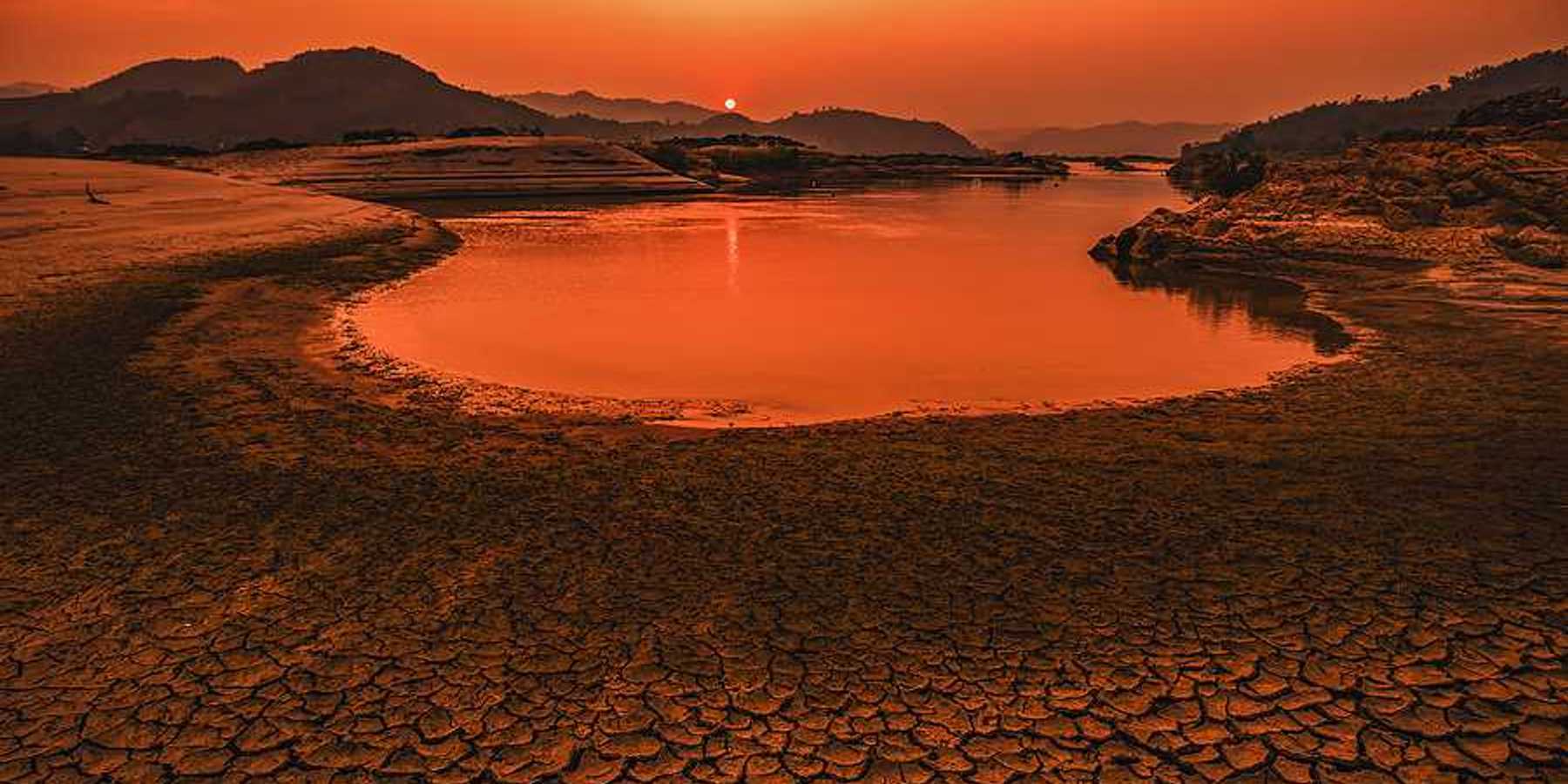 A drying lakebed under a setting sun