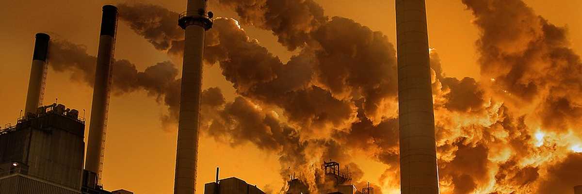 A factory or power plant with smokestacks emitting pollution