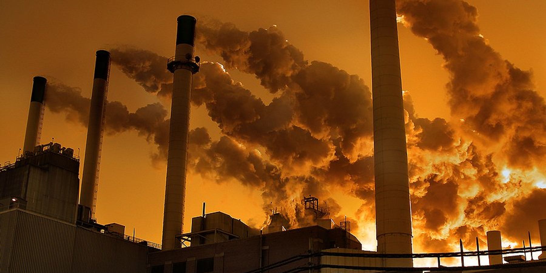A factory or power plant with smokestacks emitting pollution