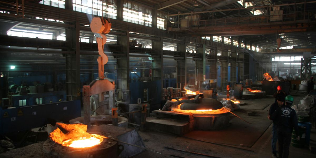 a factory with a lot of glowing molten steel.